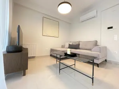 a living room with a couch and a table at Cultural Retreat Near Stavros Niarchos Center in Athens