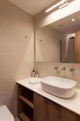 a bathroom with a white sink and a mirror at Heart of Athens Suites in Athens