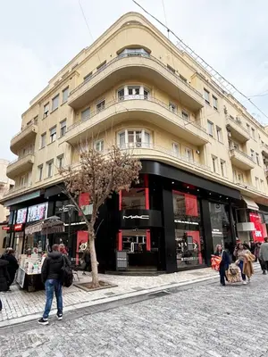 a large building with people standing outside of it at Heart of Athens Suites in Athens