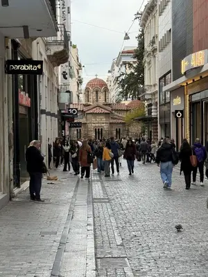 a group of people walking down a street at Heart of Athens Suites in Athens