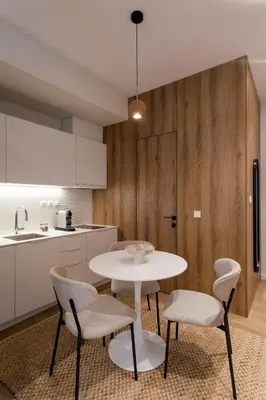 a kitchen with a table and chairs in a room at Heart of Athens Suites in Athens