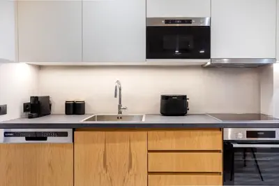a kitchen with a sink and a microwave at Plaka Clio Apartment by A&A Residences in Athens