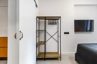 a room with a bed and a glass closet at Plaka Clio Apartment by A&A Residences in Athens