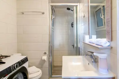 a bathroom with a shower and a sink and a toilet at Stylish 2-Bedroom Apartment with Big Terrace in Athens in Athens