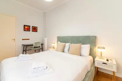 a bedroom with a large white bed and a desk at Stylish 2-Bedroom Apartment with Big Terrace in Athens in Athens