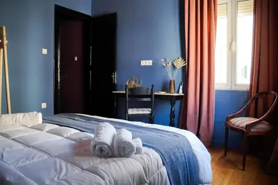 a bedroom with a bed with white towels on it at Classic and spacious apartments in Athens in Athens