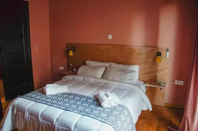 a bedroom with a large bed with towels on it at Classic and spacious apartments in Athens in Athens