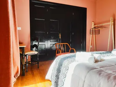 a bedroom with a bed and a black door at Classic and spacious apartments in Athens in Athens
