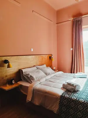 a bedroom with a large bed and a window at Classic and spacious apartments in Athens in Athens