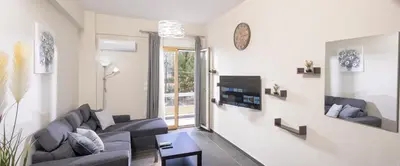 a living room with two couches and a tv at Luxury Athens Central in Athens