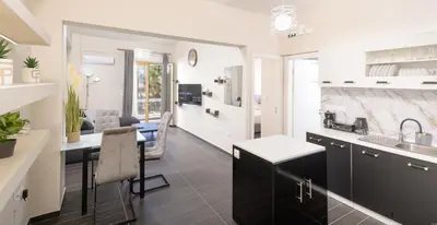 a kitchen and living room with a sink and a counter at Luxury Athens Central in Athens