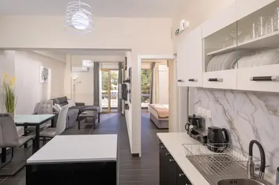 a kitchen and living room with a table and chairs at Luxury Athens Central in Athens