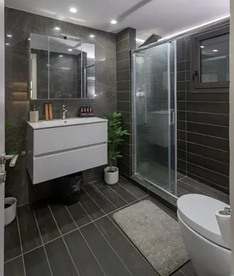 a bathroom with a sink and a shower and a toilet at Luxury Athens Central in Athens