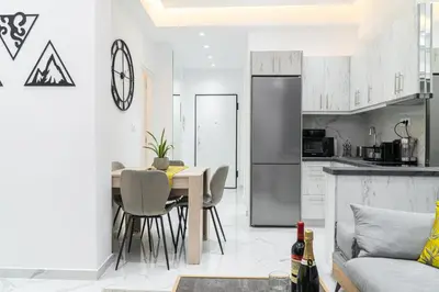 a kitchen and dining room with a table and chairs at Diamond Downtown Kolonaki in Athens