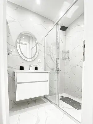 a white bathroom with a sink and a shower at Diamond Downtown Kolonaki in Athens
