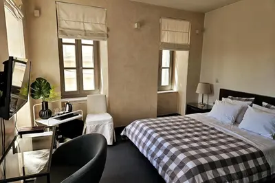 a hotel room with a bed and a chair at Evangelia1 Comfortable room, Exquisite View in Athens