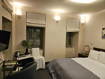 a bedroom with a bed and a desk and a television at Evangelia1 Comfortable room, Exquisite View in Athens