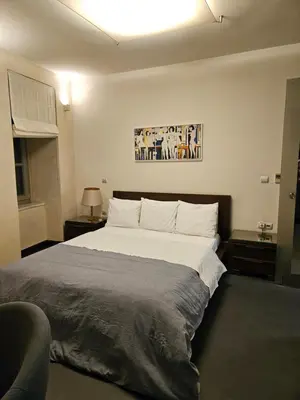 a bedroom with a large bed with white pillows at Evangelia1 Comfortable room, Exquisite View in Athens