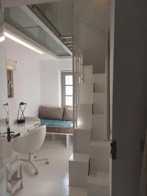 a white room with a staircase and a desk at Evangelia2 The 