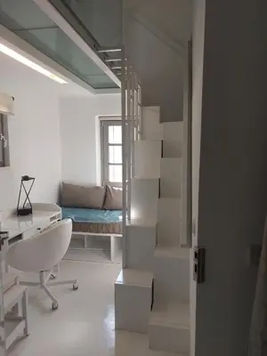a white room with a staircase and a bed at Evangelia2 The 