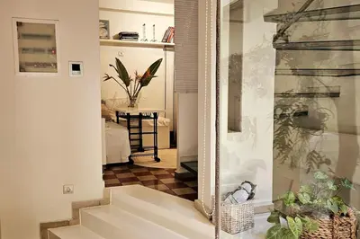 a hallway with a mirror and stairs in a room at Evangelia2 The 
