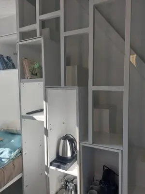 a white book shelf in a room at Evangelia2 The 