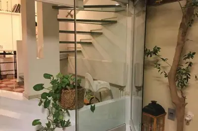 a glass wall with plants in a room at Evangelia3 Attic with Amazing View Patio in Athens