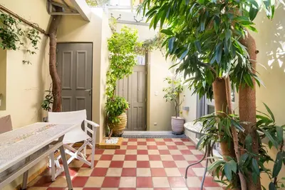 a courtyard with plants and a checkered floor at Evangelia3 Attic with Amazing View Patio in Athens