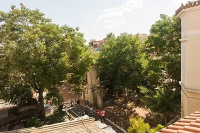 a group of people walking around a park with trees at Evangelia3 Attic with Amazing View Patio in Athens