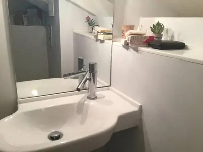 a bathroom with a sink with a mirror and a mirror at Evangelia3 Attic with Amazing View Patio in Athens