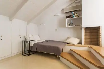 a bedroom with a bed and a table in a room at Evangelia3 Attic with Amazing View Patio in Athens