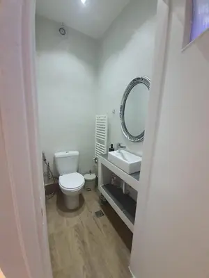 a bathroom with a toilet and a sink and a mirror at Apartment fbi2 in Athens