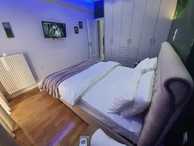 a bedroom with a large bed with white sheets at Apartment fbi2 in Athens