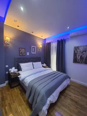 a bedroom with a large bed with blue lighting at Apartment fbi2 in Athens