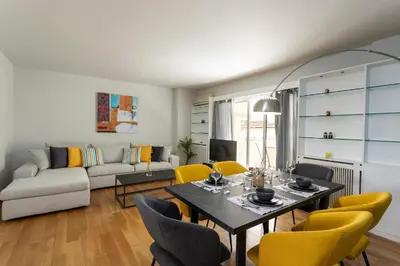 a living room with a table and yellow chairs at YestayHomes Two Bedroom Apartment Aristipou in Athens