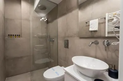a bathroom with a toilet and a sink and a shower at YestayHomes Two Bedroom Apartment Aristipou in Athens
