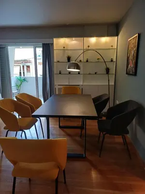 a dining room with a table and chairs at YestayHomes Two Bedroom Apartment Aristipou in Athens