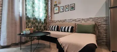 a living room with a couch and a table at Ilisia apartment for rent in Athens