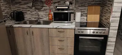 a kitchen with a sink and a microwave at Ilisia apartment for rent in Athens
