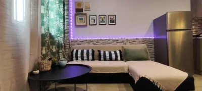 a living room with a couch and a table at Ilisia apartment for rent in Athens