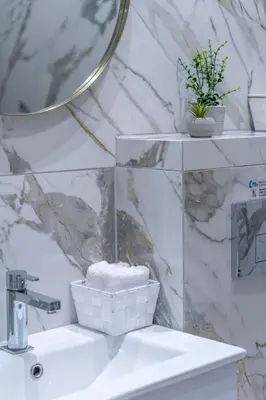a white bathroom with a sink and a mirror at The HostMaster Timeless Elegance in Athens