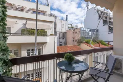 a balcony with a table and chairs on a building at The HostMaster Timeless Elegance in Athens