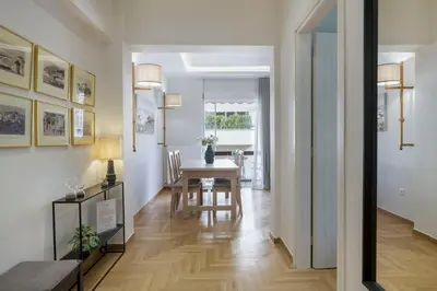 a hallway with a table and a dining room at The HostMaster Timeless Elegance in Athens