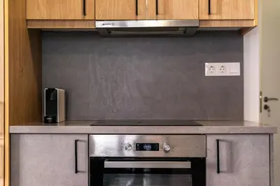 a kitchen with a stainless steel stove top oven at 3 Bedroom Gem at METRO in Athens
