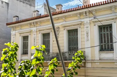 a yellow building with windows and a balcony at 3 Bedroom Gem at METRO in Athens