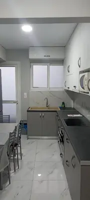 a kitchen with a sink and a counter top at Michali's Sepolia Agios Meletis Apartment in Athens