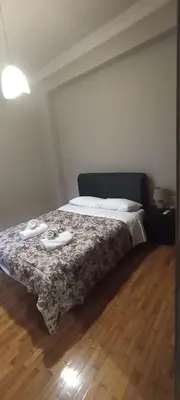 a bedroom with a bed with two shoes on it at Michali's Sepolia Agios Meletis Apartment in Athens