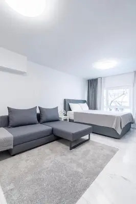 a living room with a couch and a bed at Modern Gem in Central Athens in Athens