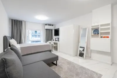 a white room with a bed and a couch at Modern Gem in Central Athens in Athens