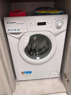 a white washing machine sitting in a room at Modern Gem in Central Athens in Athens